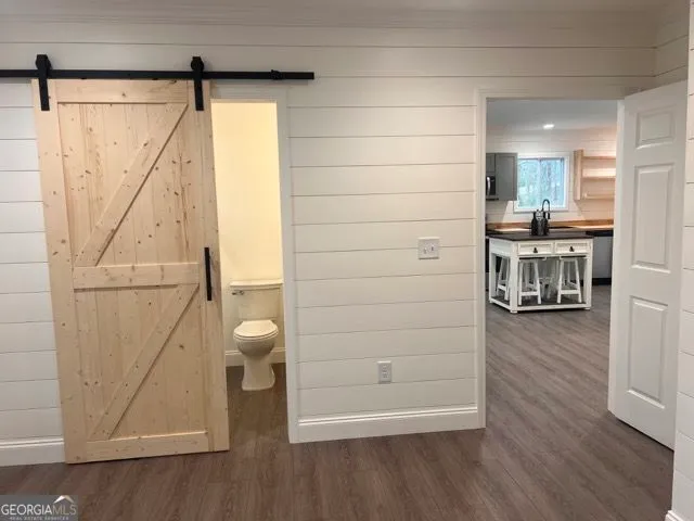 a dining room with furniture and wooden floor