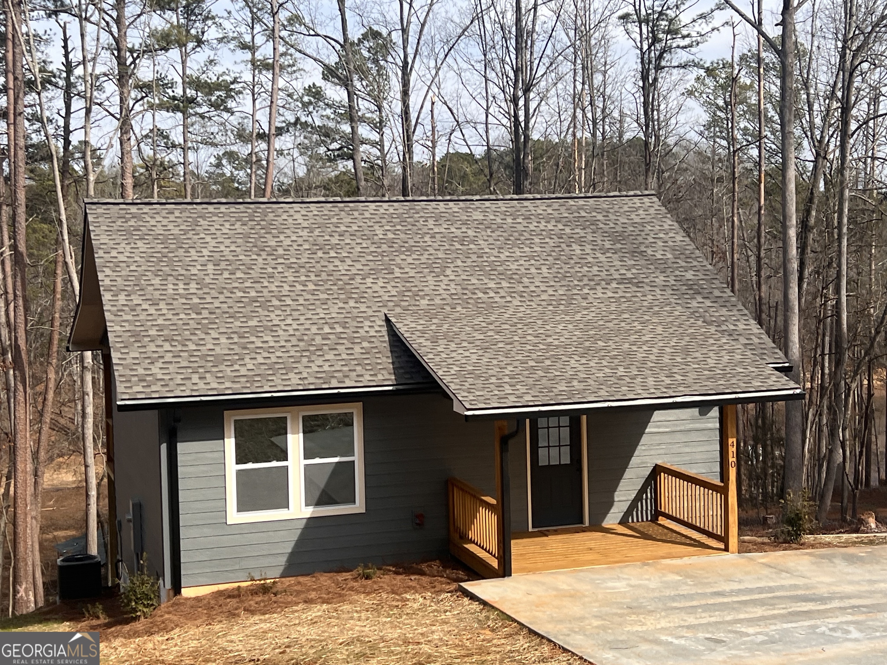 410 Lakeside Hills Road Martin, GA 30557 - Photo 3 of 71 a backyard of a house with large trees and wooden fence