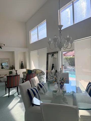 a living room with furniture and chandelier