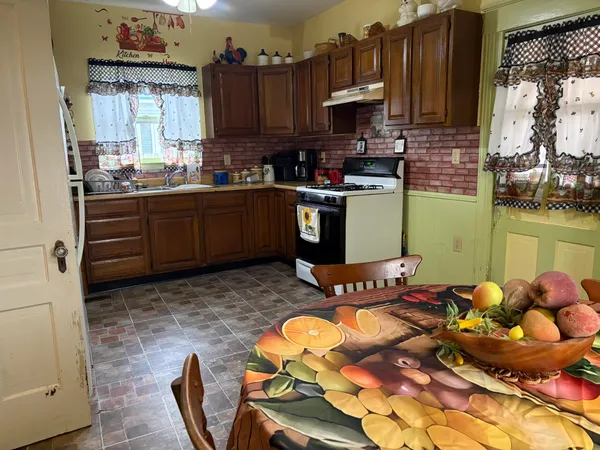 a kitchen with stainless steel appliances granite countertop a refrigerator and a stove top oven