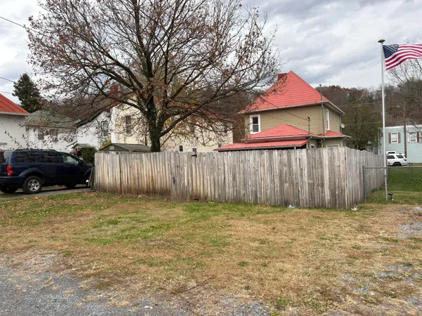 a view of a house with a couches and a large tree