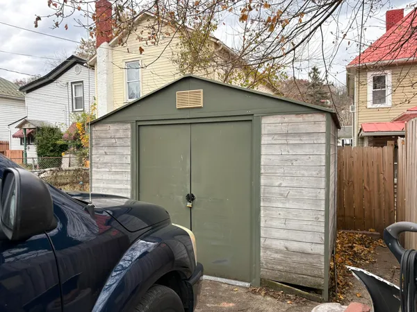 a view of backyard with wooden fence