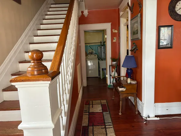 a view of entryway and hall with wooden floor