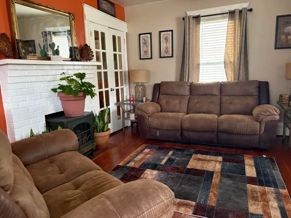 a living room with furniture fireplace and a window