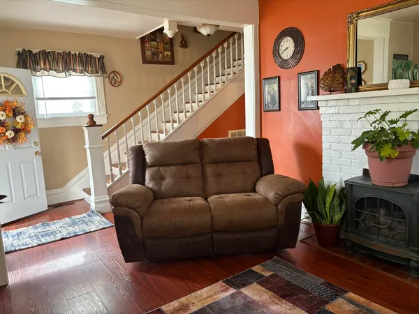 a living room with furniture a clock and a window
