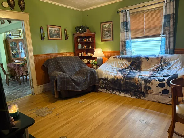 a bedroom with furniture and a wooden floor