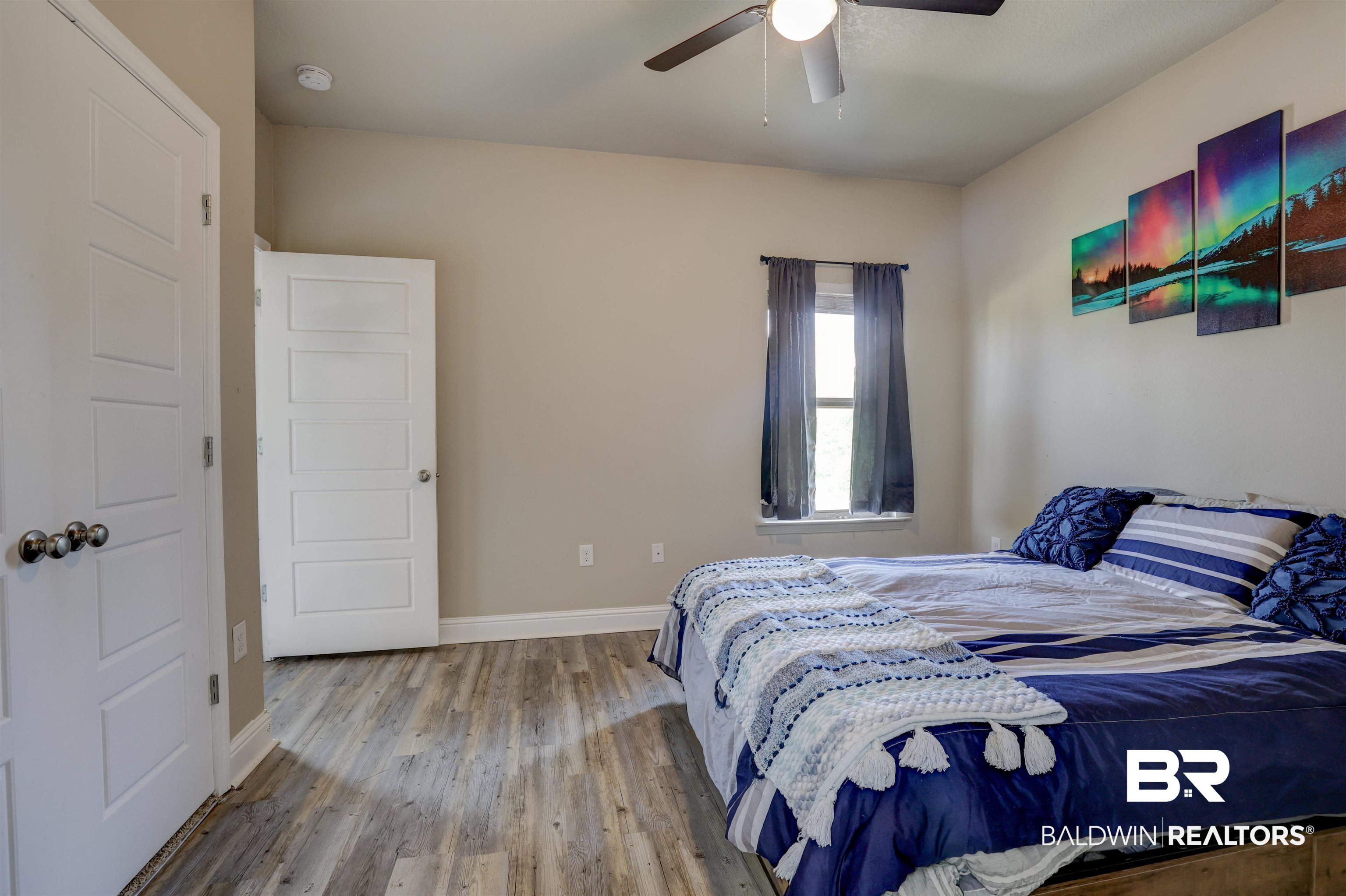 21902 Yosemite Boulevard Fairhope, AL 36532 - Photo 18 of 32 Bedroom featuring ceiling fan and hardwood / wood-style floors