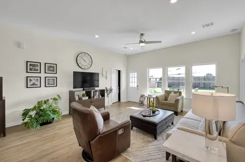 a living room with furniture and wooden floor