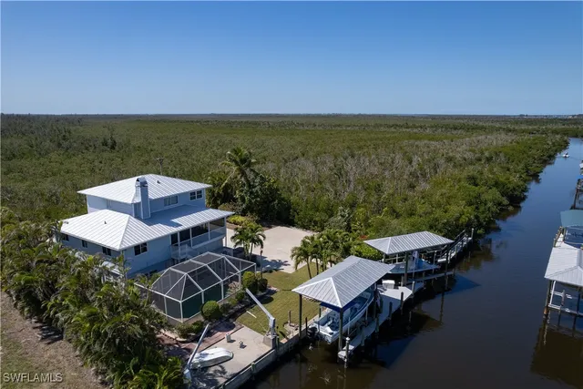 an aerial view of a house with ocean view