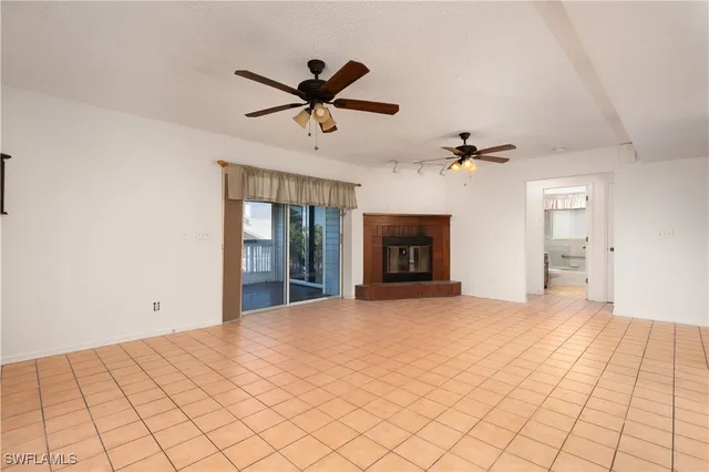 a view of an empty room with a fireplace