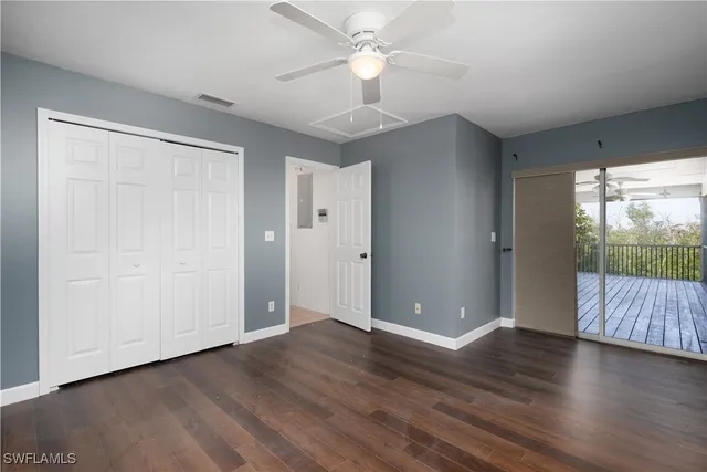an empty room with wooden floor and door