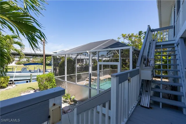 a view of a balcony with plants and wooden fence