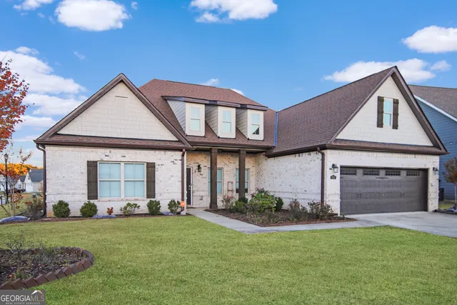 a front view of a house with a yard and garage