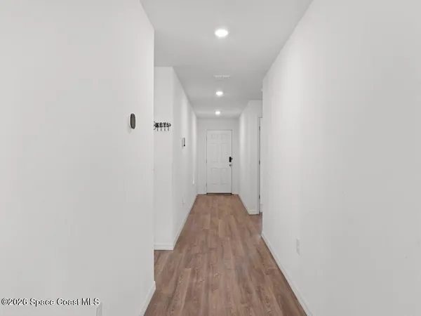 a view of hallway with wooden floor