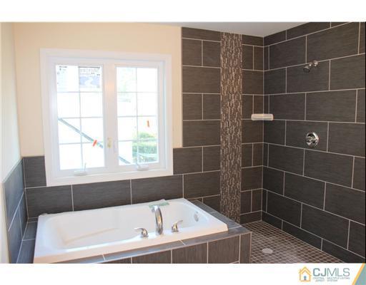 60 Sturgis Road Edison, NJ 08817 - Photo 4 of 5 a bathroom with a bath tub and a window