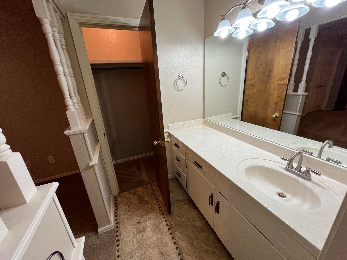 1312 Yonkers Street Plainview, TX 79072 - Photo 13 of 25 a bathroom with a sink a vanity and a mirror