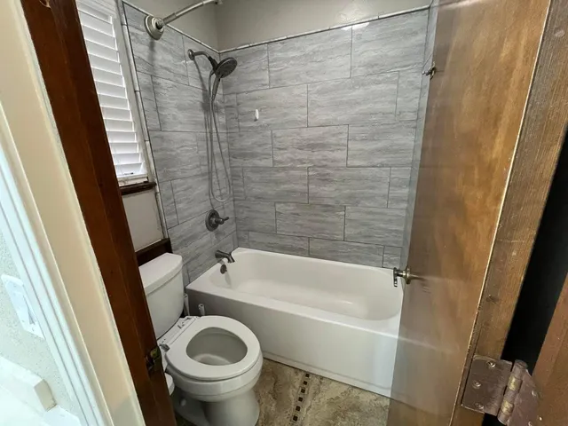 a bedroom with a bed and a ceiling fan