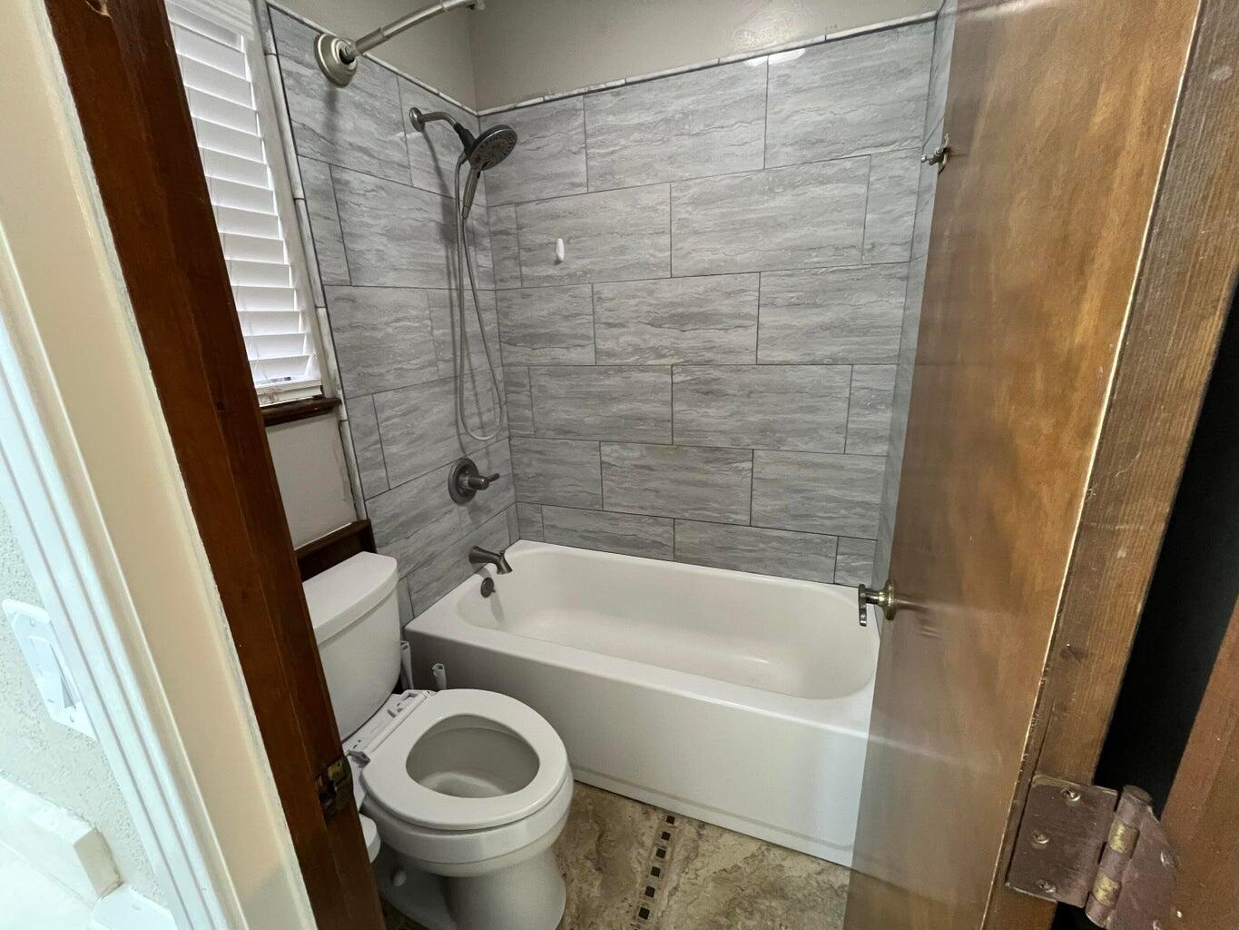 1312 Yonkers Street Plainview, TX 79072 - Photo 15 of 25 a bathroom with a tub and a shower