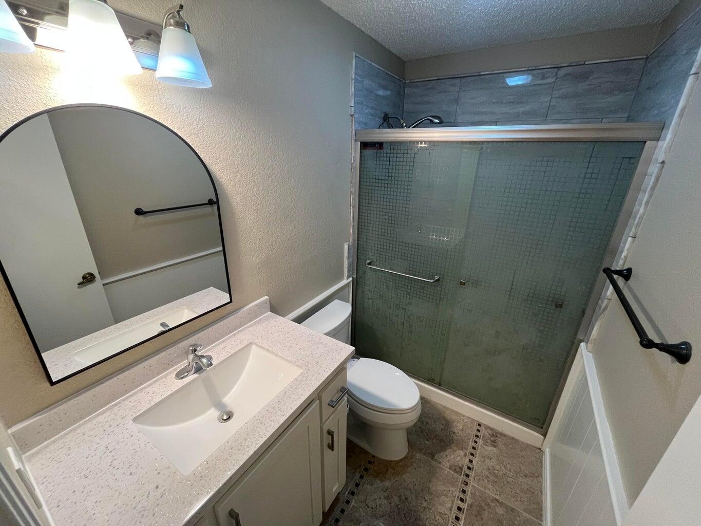 1312 Yonkers Street Plainview, TX 79072 - Photo 18 of 25 a bathroom with a sink toilet and shower