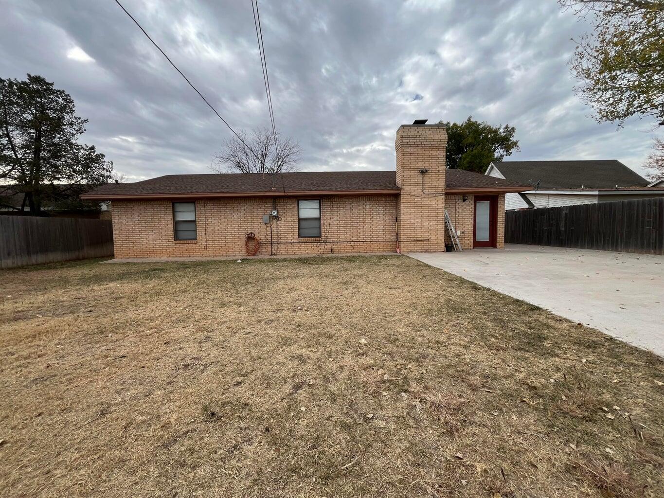 1312 Yonkers Street Plainview, TX 79072 - Photo 23 of 25 a front view of a house with a yard