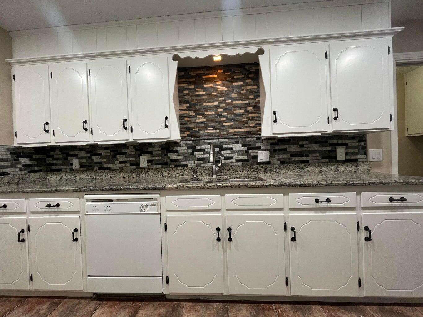 1312 Yonkers Street Plainview, TX 79072 - Photo 9 of 25 a view of white cabinets with granite countertop white cabinets