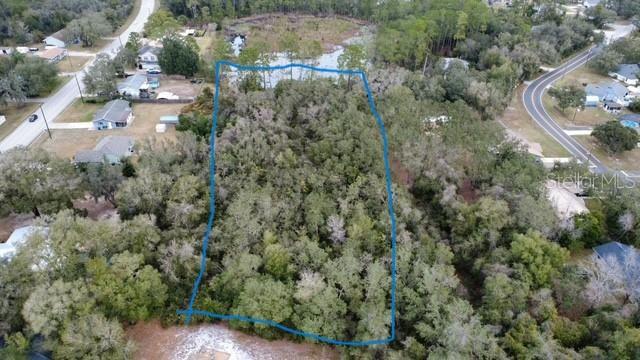 Periwinkle Drive DeLand, FL 32724 - Photo 3 of 5 an aerial view of residential house with outdoor space and trees all around
