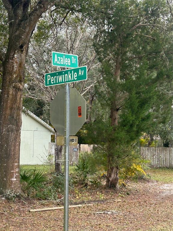 Periwinkle Drive DeLand, FL 32724 - Photo 4 of 5 a sign that is on a pole