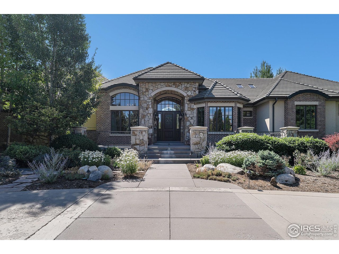 6344 Rookery Road Fort Collins, CO 80528 - Photo 9 of 40 a front view of a house with a garden