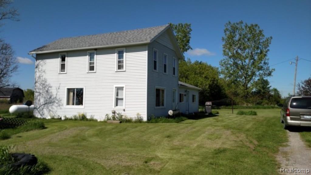 9183 Metcalf Road Avoca, MI 48006 - Photo 14 of 18 This is a side view of the home.
