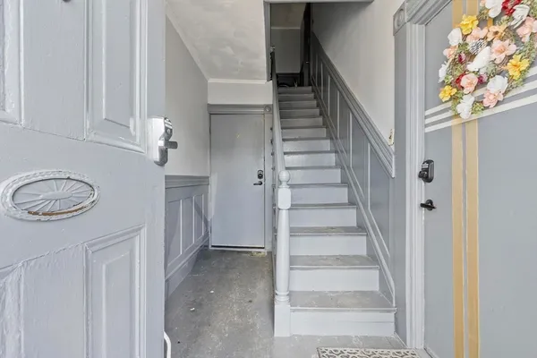 a view of a hallway with entryway and front door