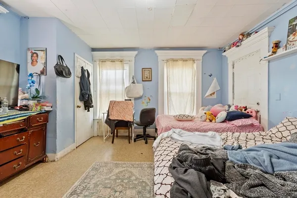 a bedroom with two beds and a dresser