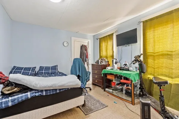 a bedroom with bed and a window