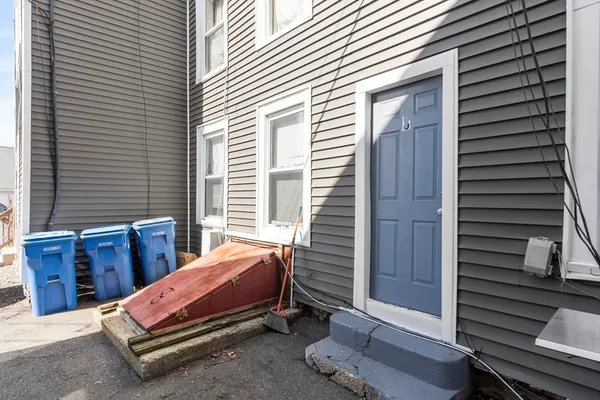 a backyard of a house with chairs and a table