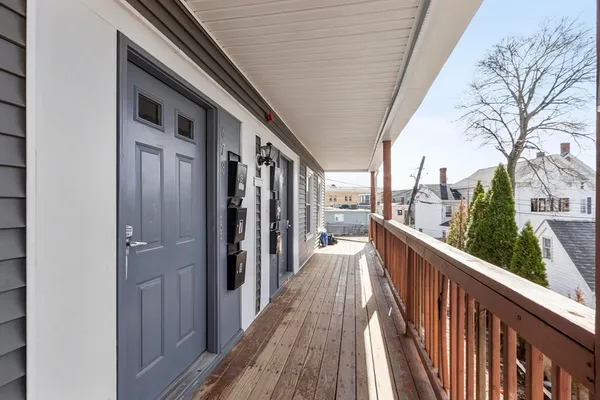 a view of a balcony with wooden floor and fence and floor