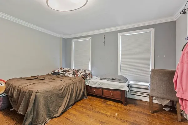 a bedroom with a bed and a chair