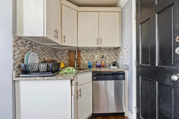 a kitchen with stainless steel appliances granite countertop a sink and cabinets