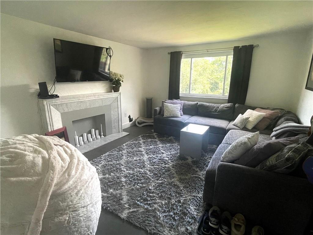 820 Etna Street McKees Rocks, PA 15136 - Photo 3 of 16 a living room with furniture and a fireplace