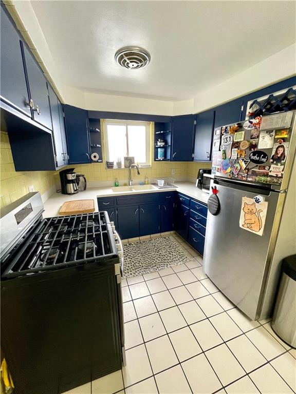 820 Etna Street McKees Rocks, PA 15136 - Photo 4 of 16 a kitchen with a stove a sink and a microwave