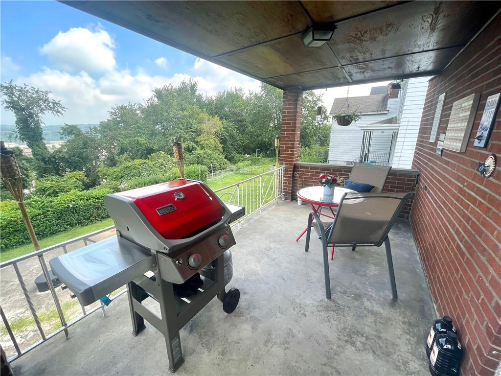 820 Etna Street McKees Rocks, PA 15136 - Photo 7 of 16 a backyard of a house with yard table and chairs