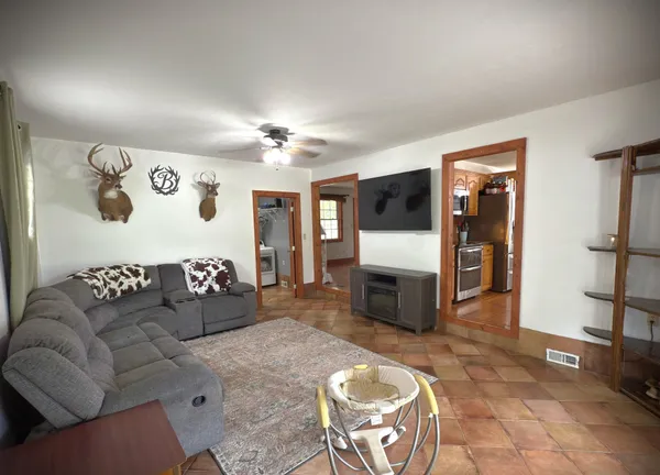 a living room with furniture a flat screen tv and a fireplace