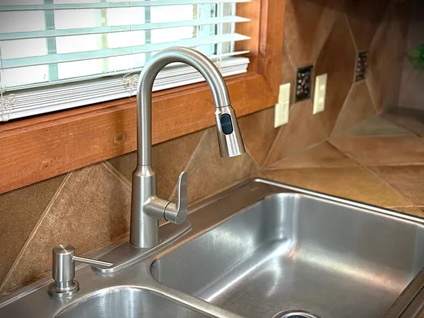 a view of a livingroom with a large window and wooden floor