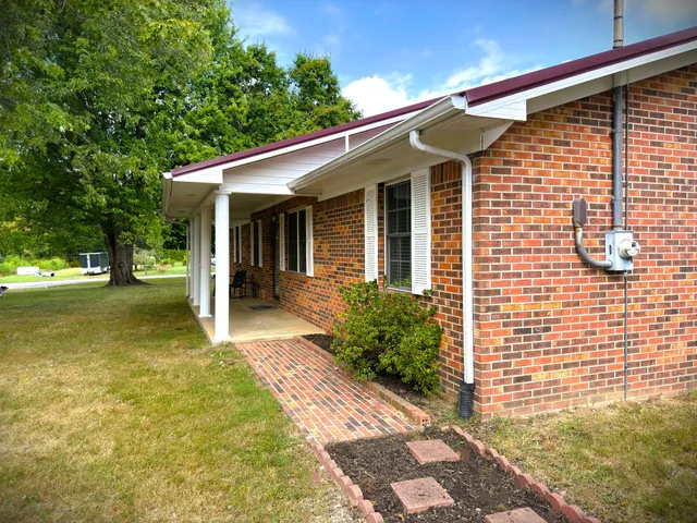 a backyard of a house with table and chairs