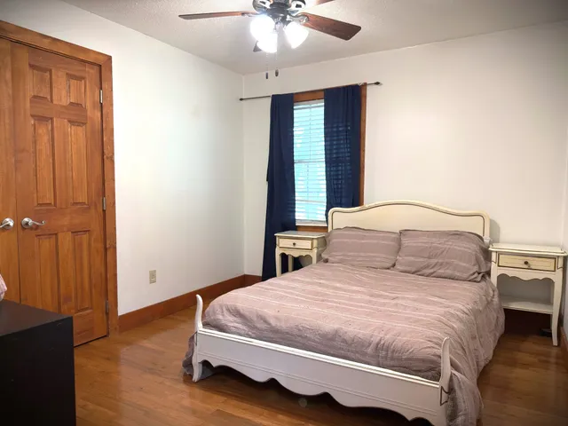 a bedroom with a bed and a window