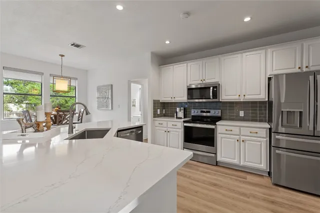 a kitchen with a refrigerator stove and microwave