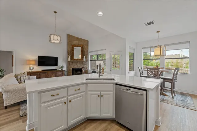 a kitchen with white cabinets and outdoor space