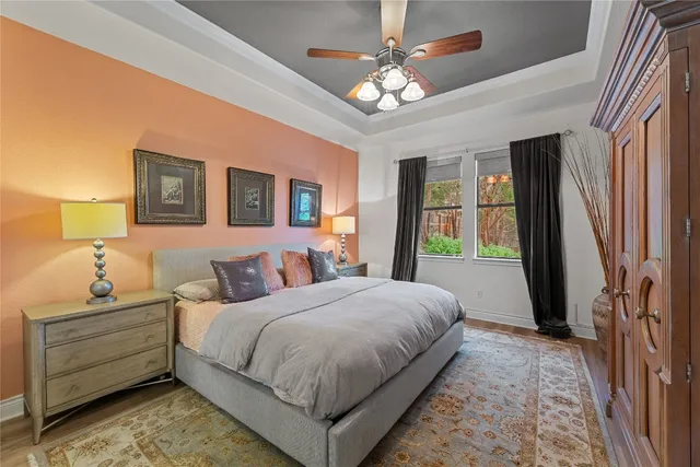 a bedroom with a large bed and a chandelier