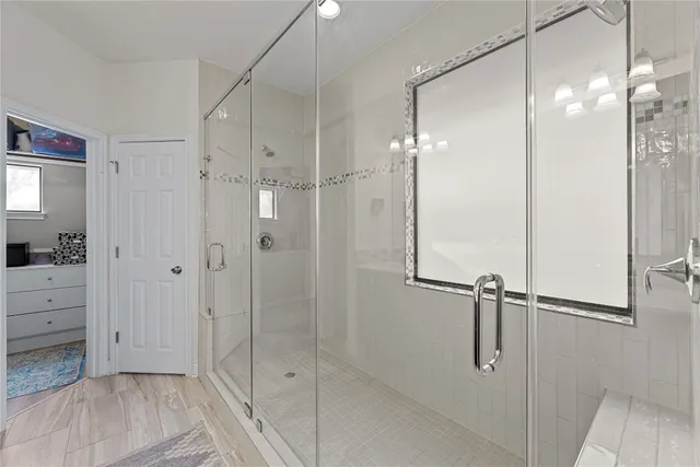 a bathroom with a shower and a sink