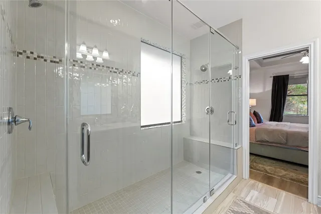 a bathroom with a glass shower door and a sink