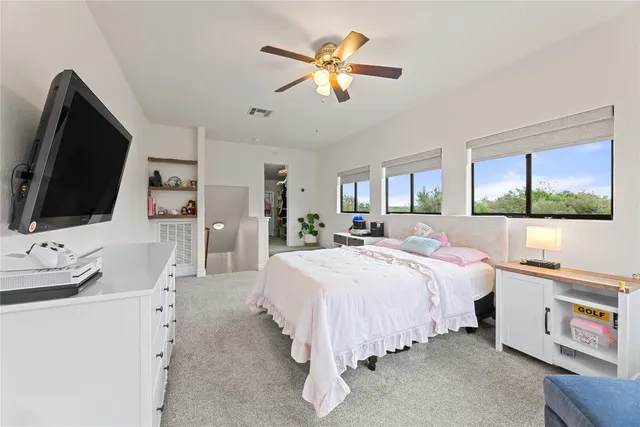 a roof deck with couches and potted plants