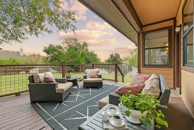 a balcony with furniture and a potted plant